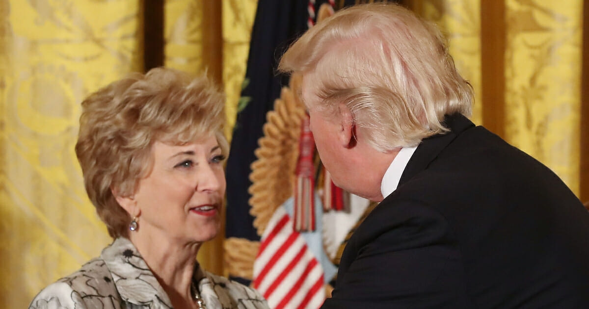 President Donald Trump greets Small Business Administration head Linda McMahon during an event celebrating Women's History Month.