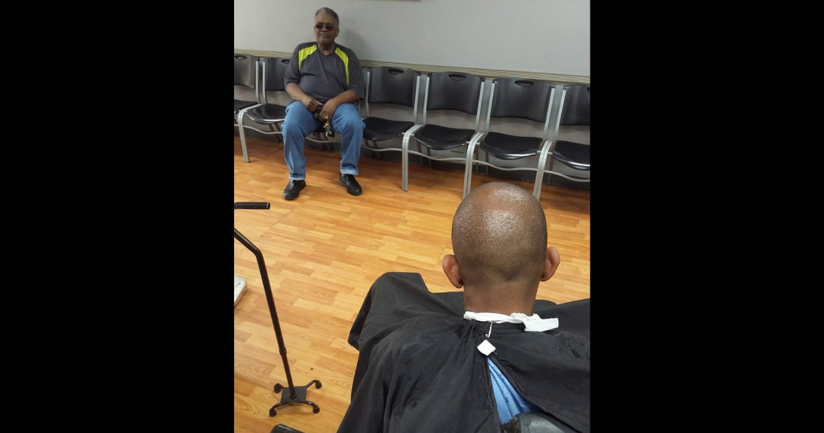 The back of a man's head in a barbershop.