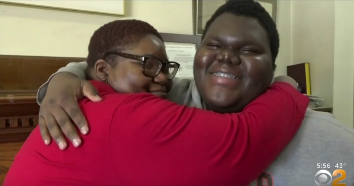 A mother hugs her son who was accepted into 17 colleges.