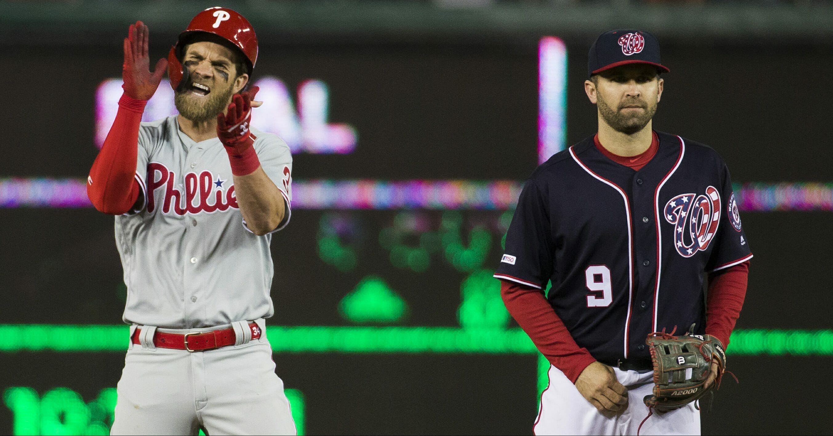 The Philadelphia Phillies' Bryce Harper, left, celebrates his RBI hit while on second base next to Washington Nationals second baseman Brian Dozier during the sixth inning April 2, 2019, at Nationals Park.