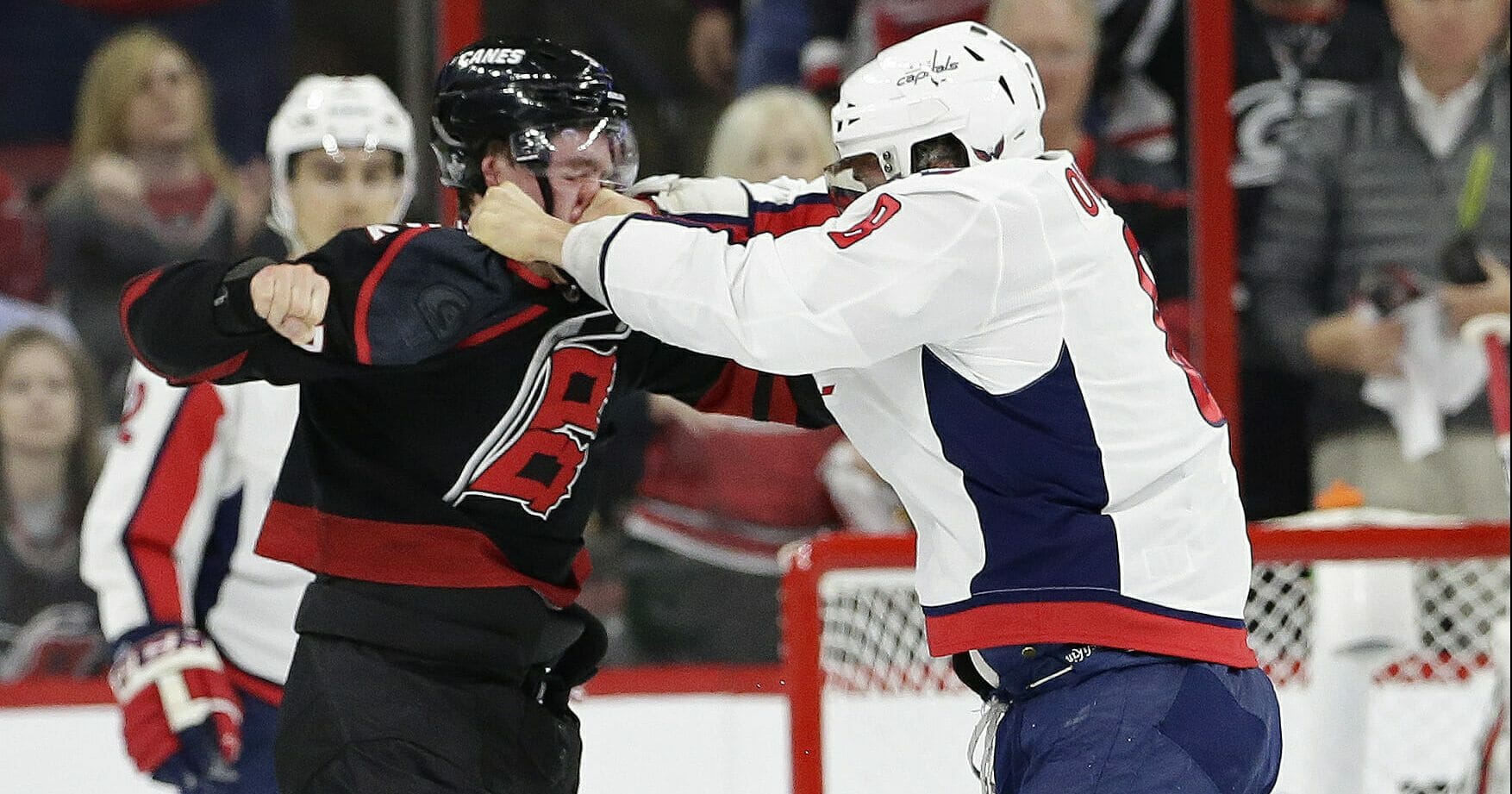 Washington Capitals' Alex Ovechkin, right, of Russia, punches Carolina Hurricanes' Andrei Svechnikov, also of Russia, during the first period of Game 3 of an NHL hockey first-round playoff series in Raleigh, N.C., Monday, April 15, 2019.