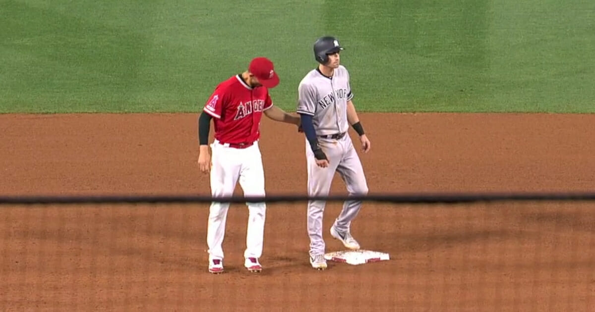 The Los Angeles Angels' Andrelton Simmons tags out the New York Yankees' Tyler Wade on a hidden ball trick.