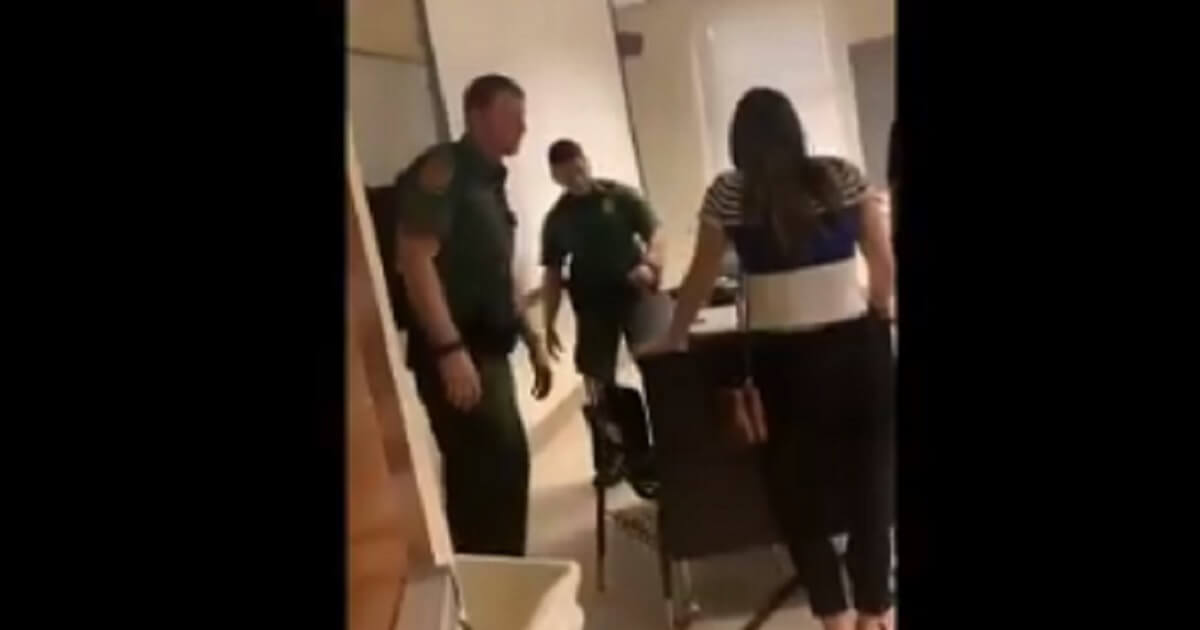 Two Border Patrol agents prepare to leave a classroom after giving a "career day" presentation at the University of Arizona.