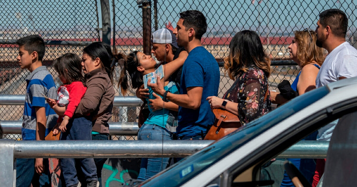 A couple says goodbye while crossing "Paso Del Norte" bridge between downtown El Paso and Ciudad Juarez, Mexico, on April 19, 2019.