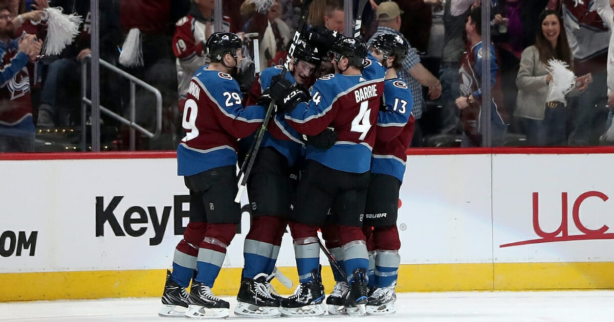 Cale Makar of the Colorado Avalanche celebrates with his teammates after scoring a goal against the Calgary Flames at the Pepsi Center on April 15, 2019.