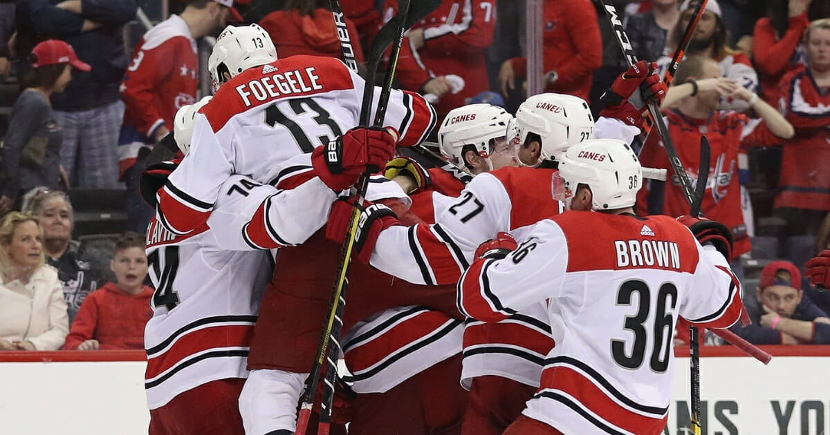 The Carolina Hurricanes celebrate their victory over the Washington Capitals in Game 7 of the Eastern Conference First Round during the 2019 NHL Stanley Cup Playoffs at the Capital One Arena on April 24, 2019, in Washington, D.C.