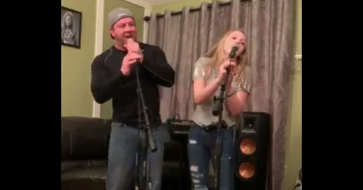 Dad and daughter singing.