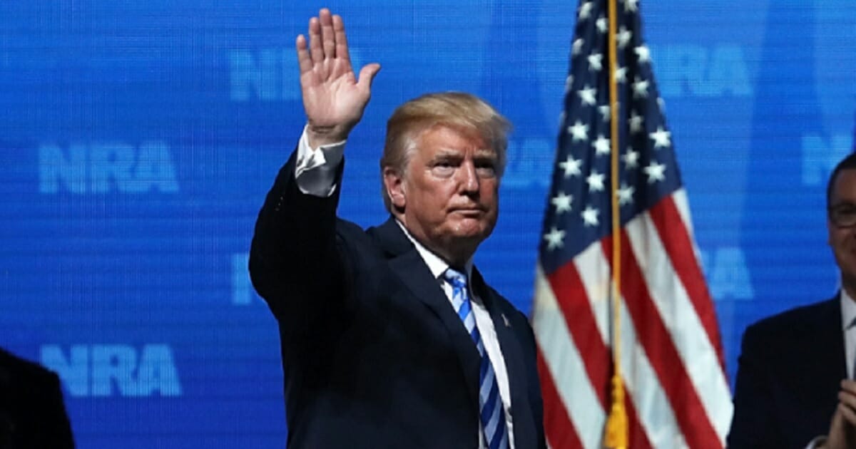 President Donald Trump waves to the crowd at the National Rifle Association's annual gathering in May 2018 in Dallas.