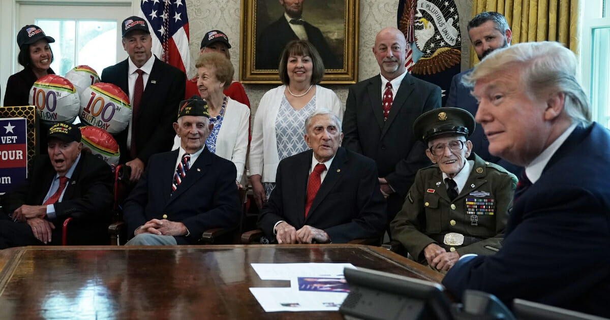 U.S. President Donald Trump meets with World War II veterans (L-R) Sidney Walton, Allen Jones, Paul Kriner and Floyd Wigfield in the Oval Office of the White House April 11, 2019, in Washington, D.C.