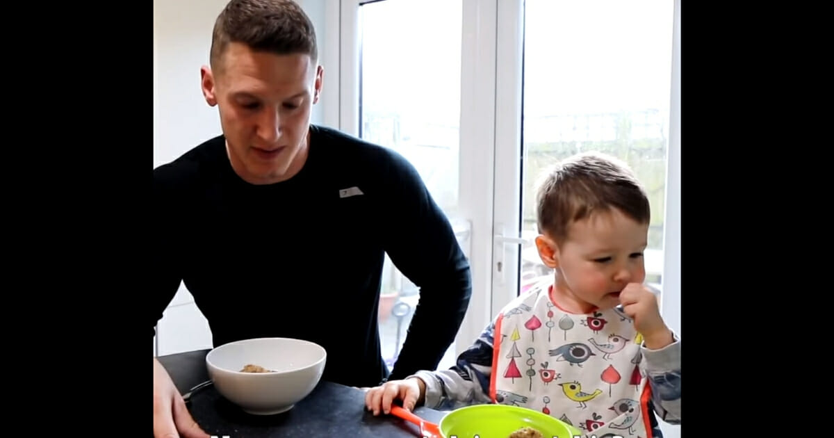 Fitness instructor dad stares at bowl of Weetabix while son happily eats his own bowl of Weetabix.