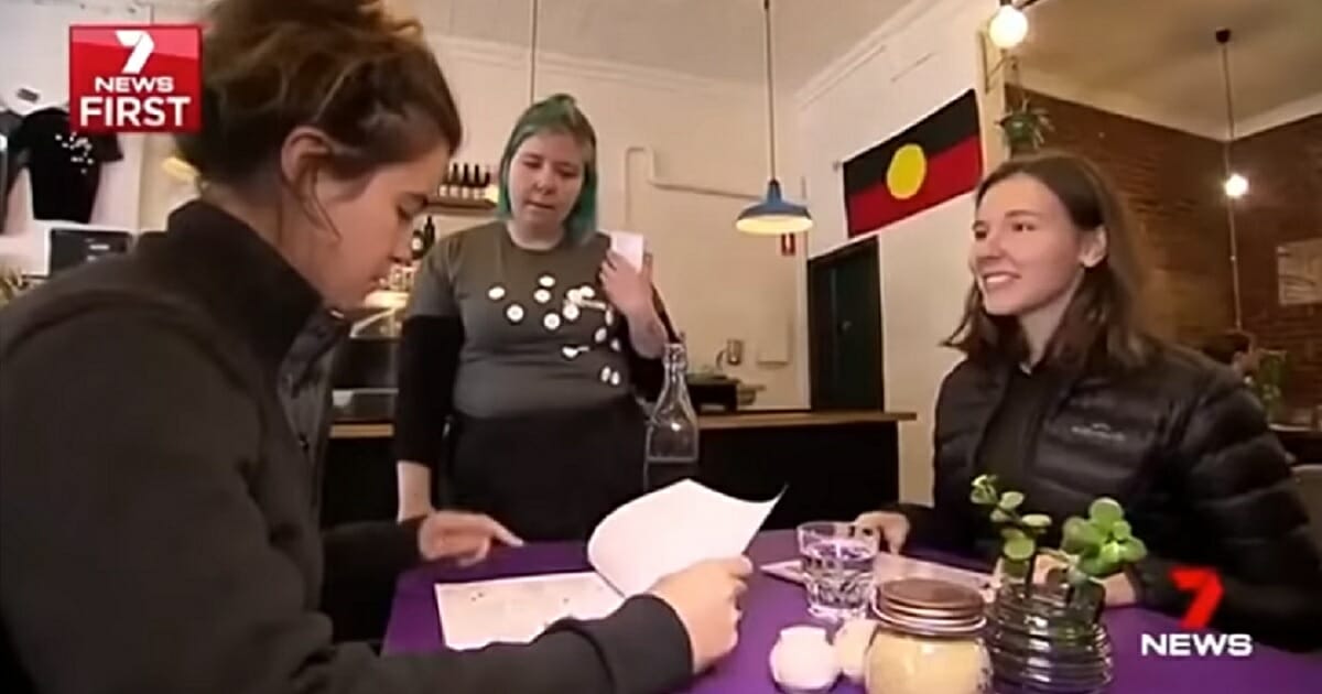 Two women order from a waitress.