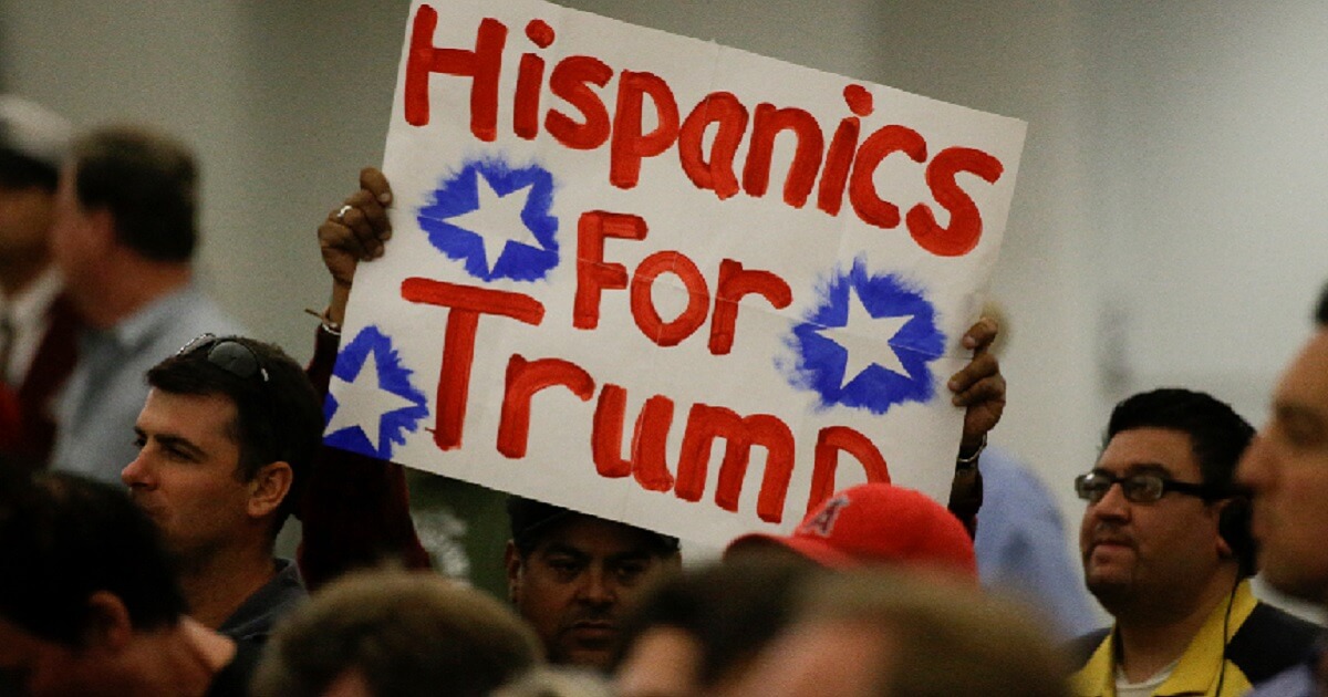 Hispanic supporters of the Donald Trump campaign carry a sign at a rally in May 2016 in Anaheim, California.