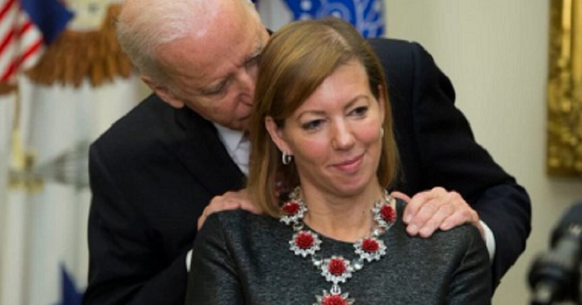 Then Vice President Joe Biden puts his hands on the shoulders of Stephanie Carter in February 2005, as Carter's husband, Ashton, was introduced as defense secretary.
