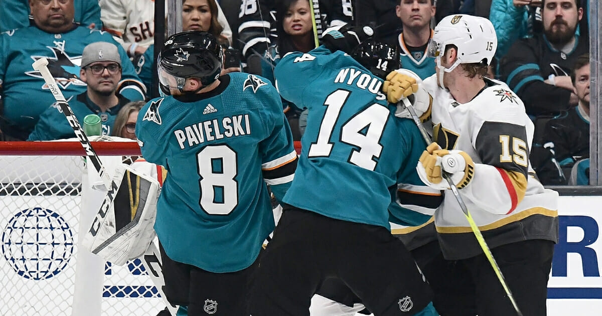 Joe Pavelski, left, of the San Jose Sharks scores a goal off his face against the Vegas Golden Knights in Game 1 of their Stanley Cup Playoffs series April 10, 2019, in San Jose, Calif.