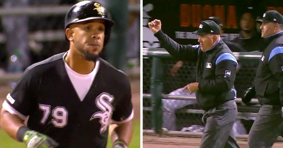 Jose Abreu of the Chicago White Sox, left, and umpires, right.