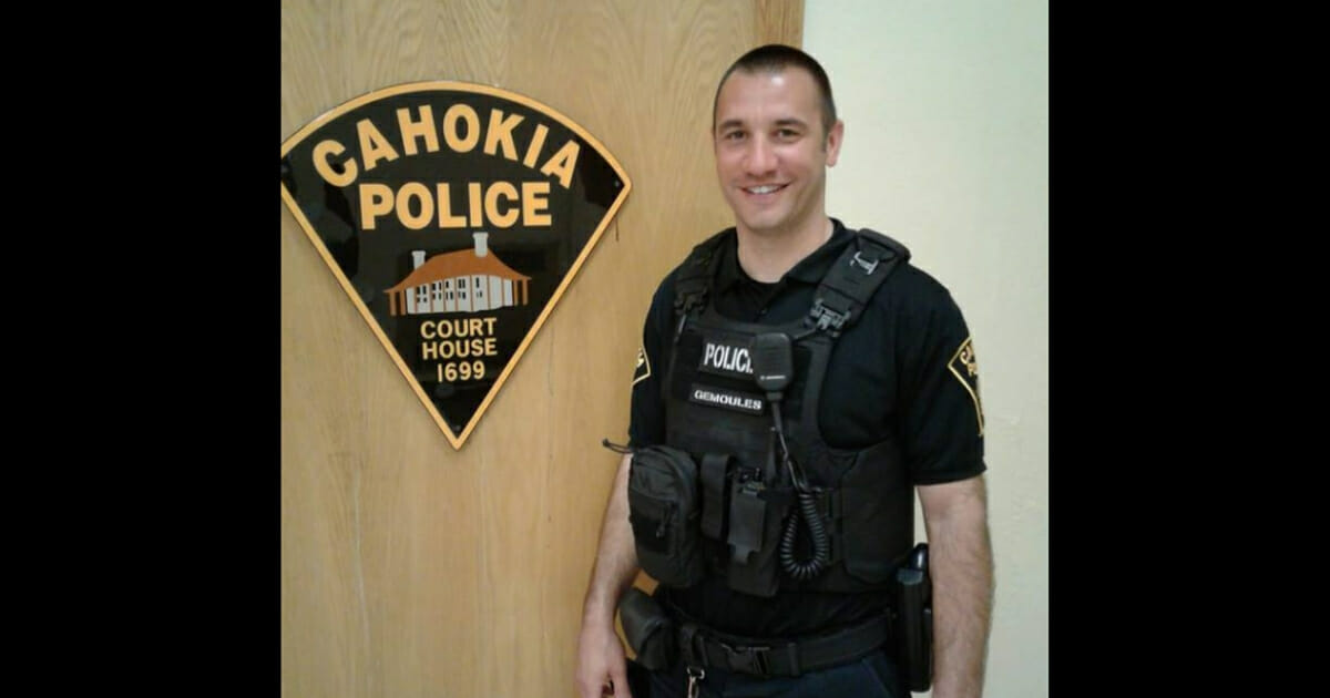 Officer Gemoules standing next to a Cahokia Police sign.
