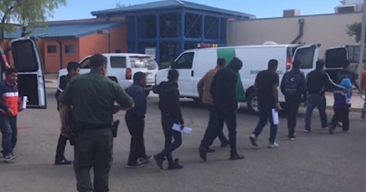 Illegal immigrants with Border Patrol agents.