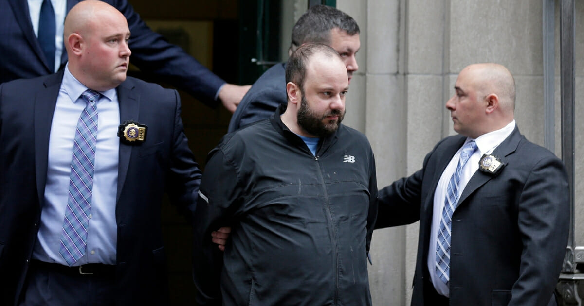 Marc Lamparello, 37, is escorted out of a police precinct in New York on April 18, 2019.