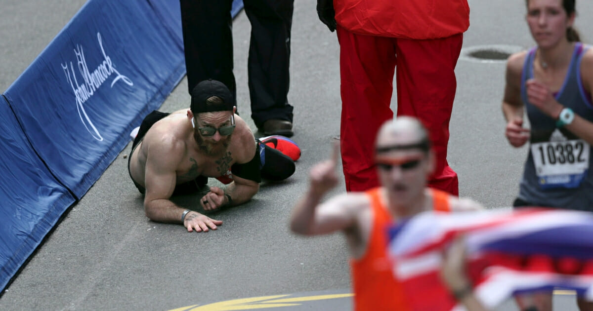 Micah Herndon, of Tallmadge, Ohio, crawls to the finish line in the 123rd Boston Marathon on April 15, 2019.