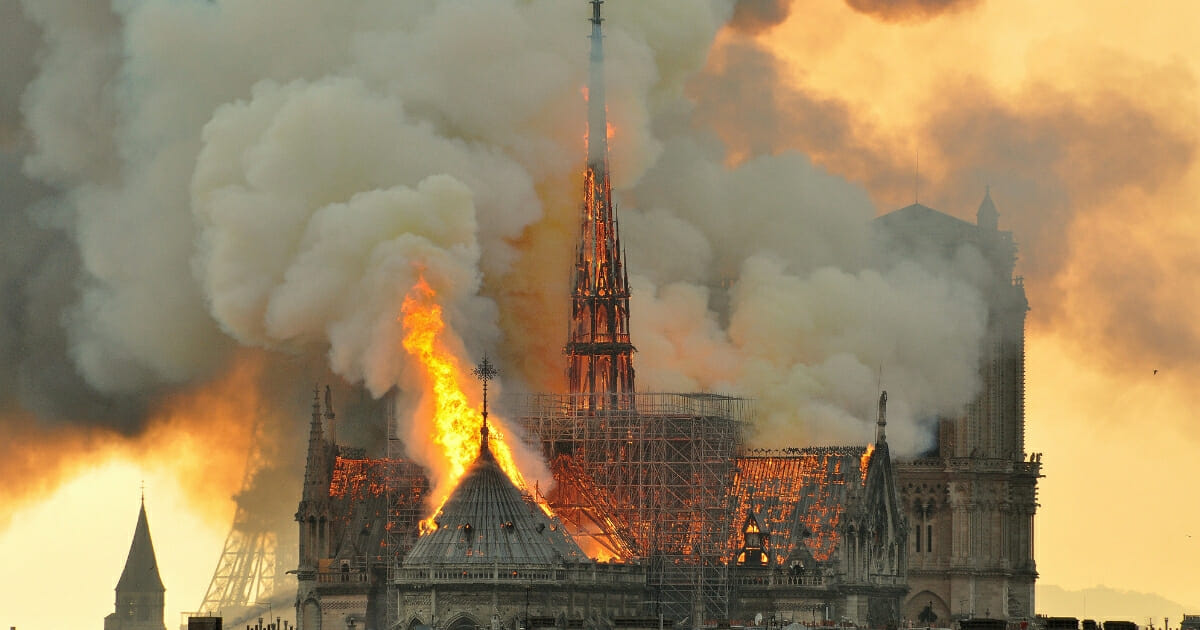 The cathedral roof goes up in flames.