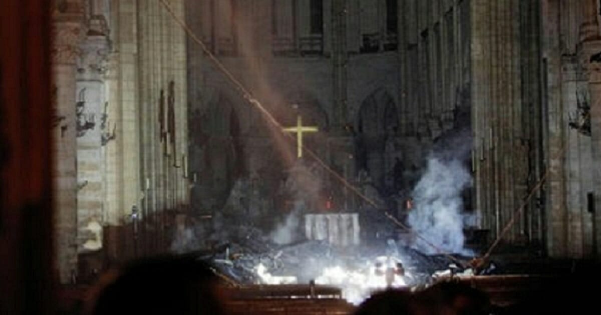 The inside of fire-ravaged Notre Dame cathedral in Paris shows the building's cross and altar survived the April 15 blaze.