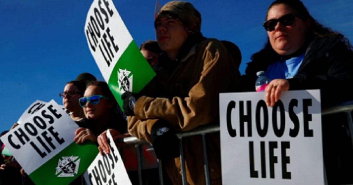 Pro-life demonstrators carry signs that say "Choose Life."