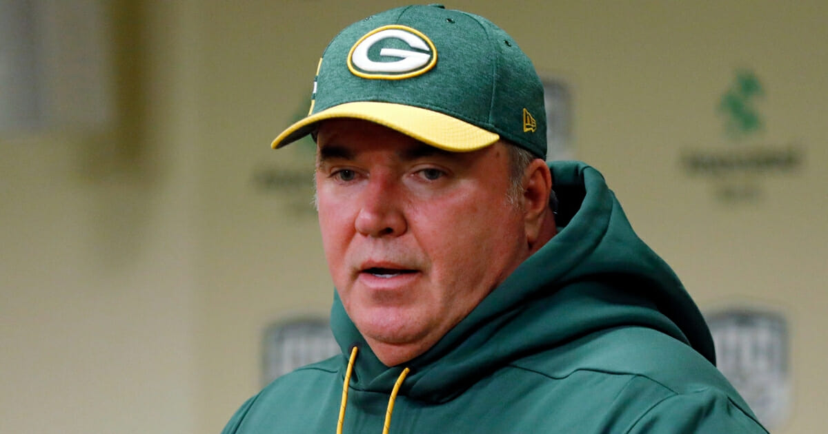 Green Bay Packers head coach Mike McCarthy talks to reporters.