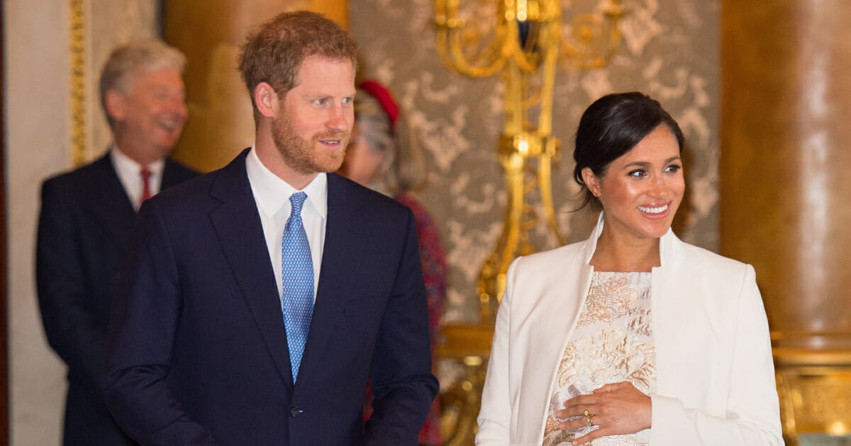 Britain's Prince Harry, Duke of Sussex, (Left) and Britain's Meghan, Duchess of Sussex (Right) attend a reception to mark the 50th Anniversary of the investiture of The Prince of Wales at Buckingham Palace in London on March 5, 2019.