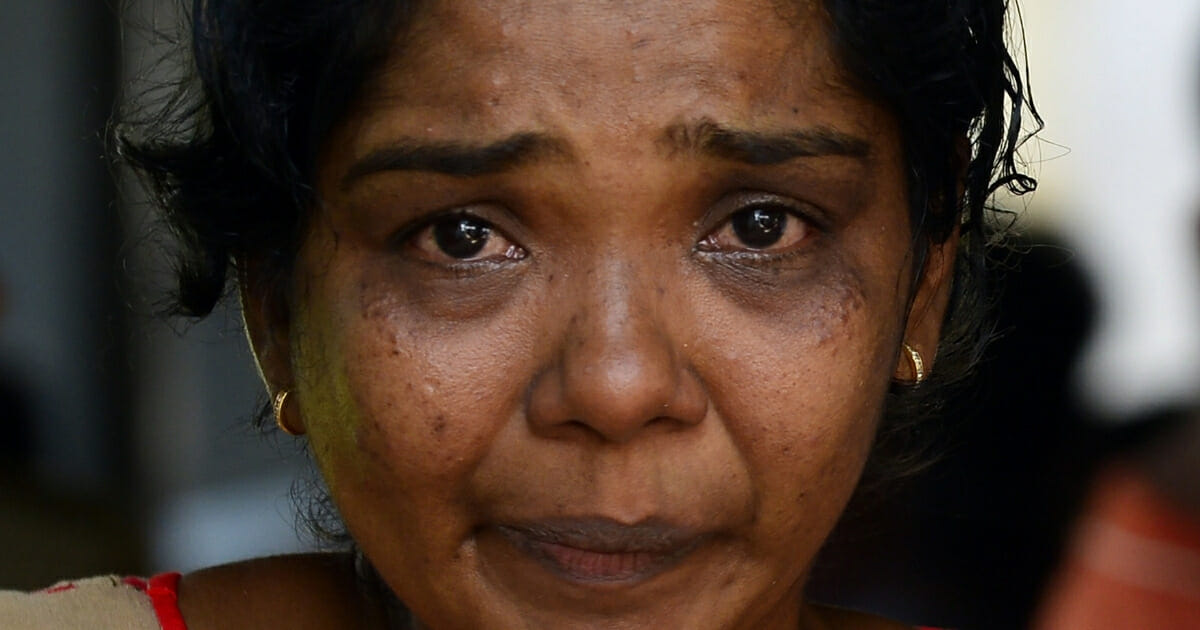 A Sri Lankan relative of a bomb blast victim weeps at a morgue in Colombo on April 22, 2019, as people gather hoping to identify loved ones missing or killed in the Easter Sunday attacks on churches and hotels.