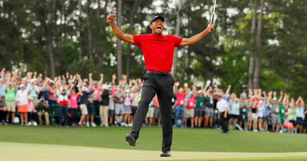 Tiger Woods celebrates after making his putt on the 18th green to win the Masters at Augusta National Golf Club on April 14, 2019.