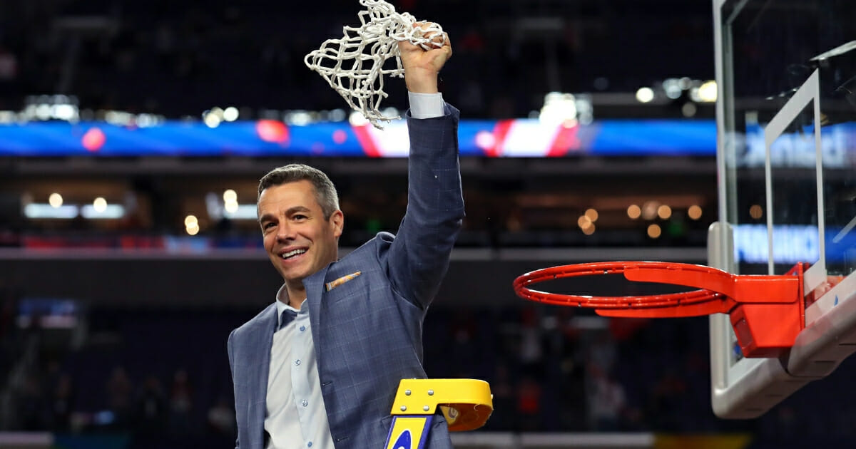 Virginia basketball coach Tony Bennett cuts down the net after the Cavaliers beat Texas Tech to win the national championship.