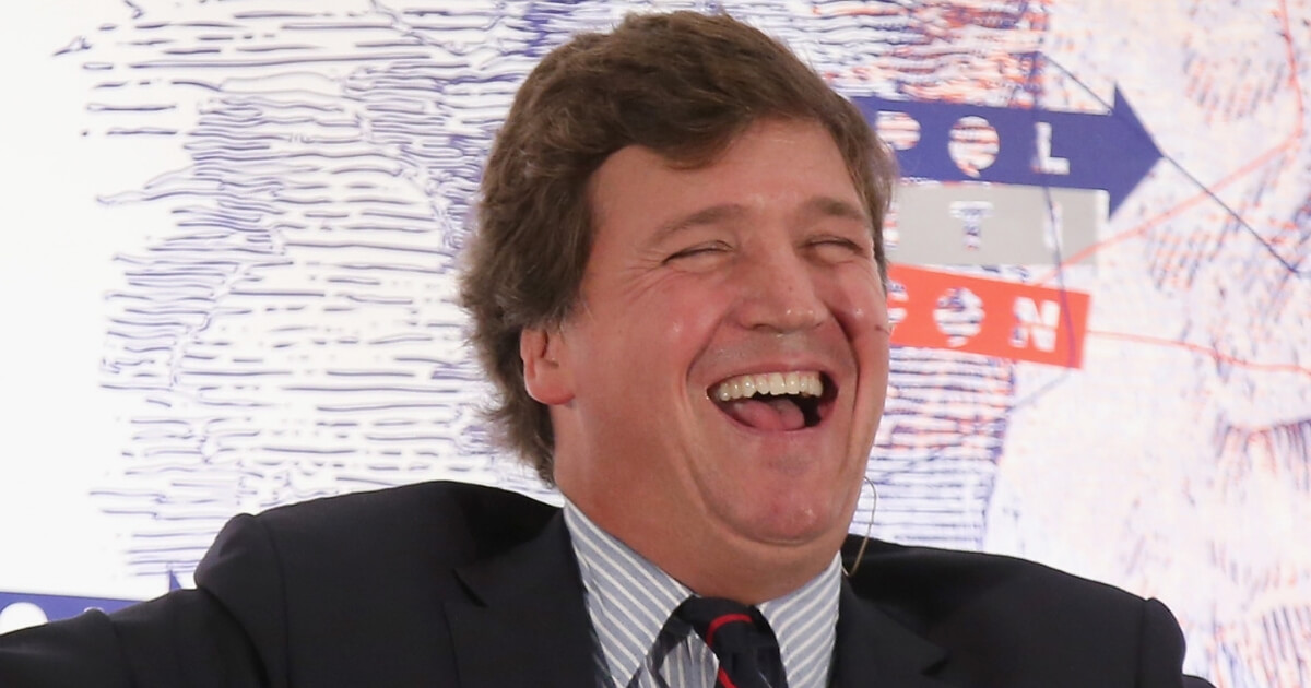 Tucker Carlson laughs during Politicon 2018 at the Los Angeles Convention Center on October 21.