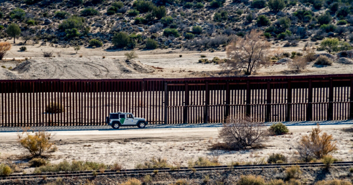 A vehicle drives along the U.S.-Mexican border in Southern California.