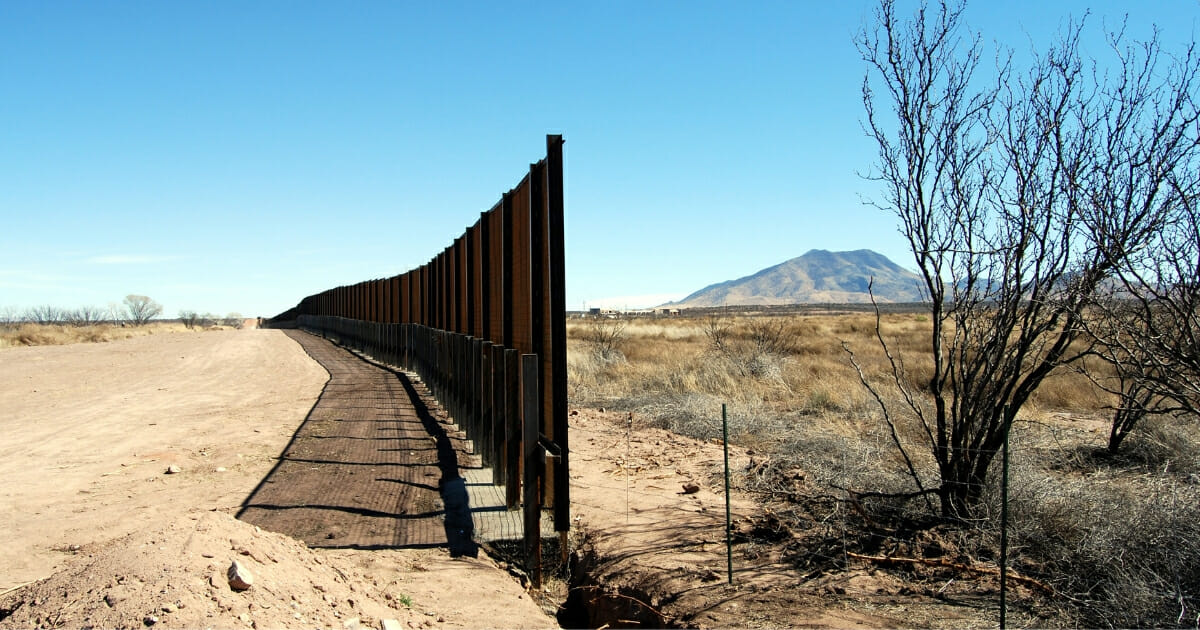 A Mexico-U.S. border fence under construction in the Arizona desert.