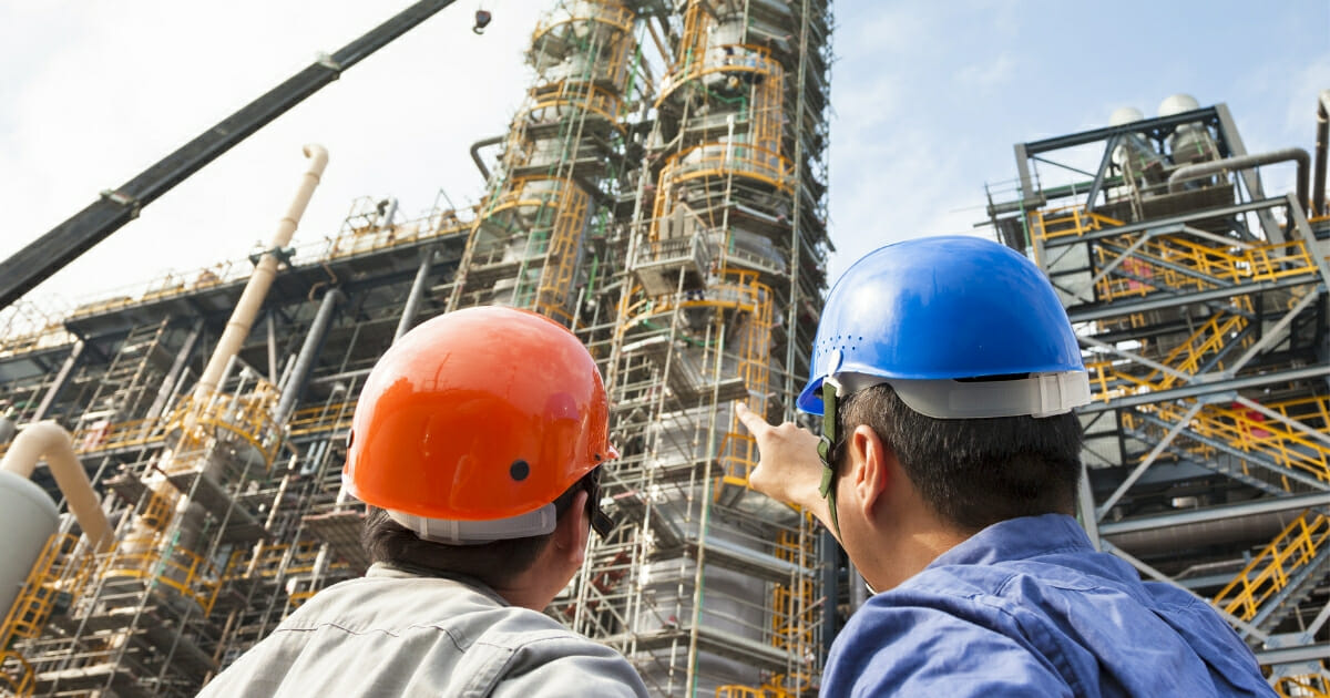 U.S. workers survey a construction site.