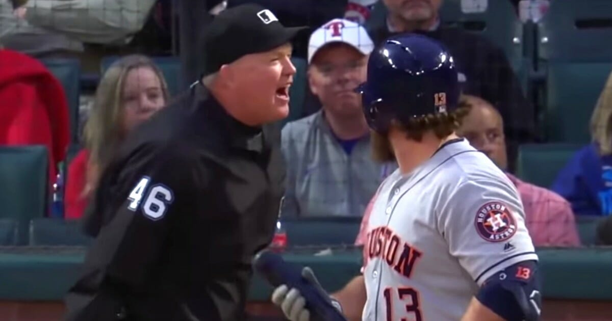Home-plate umpire Ron Kulpa stopped game action between the Houston Astros and Texas Rangers to take his mask off and yell toward the Astros' bench.