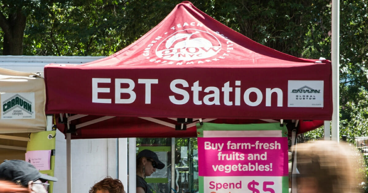 Signs advertise acceptance of "electronic benefits transfers" -- better known as food stamps -- at a farmers market in New York City's \Union Square in September 2013.