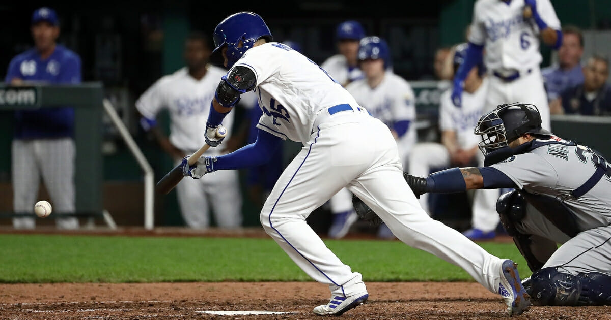 Whit Merrifield of the Kansas City Royals bunts during the 7th inning against the Seattle Mariners at Kauffman Stadium on April 10, 2019, in Kansas City, Mo.