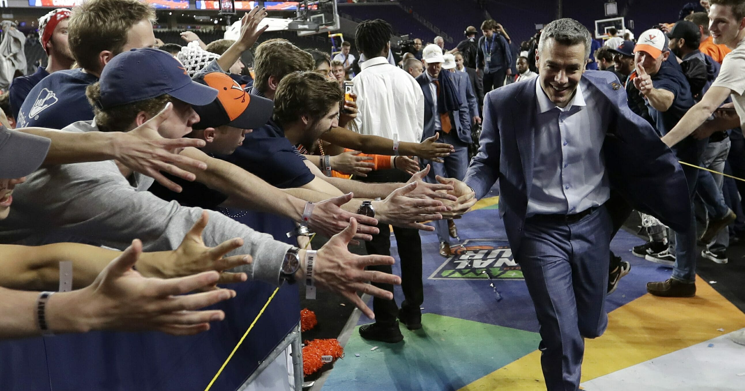 Virginia head coach Tony Bennett celebrates with fans after the championship game against Texas Tech in the Final Four NCAA college basketball tournament, Monday, April 8, 2019, in Minneapolis. Virginia won 85-77 in overtime.