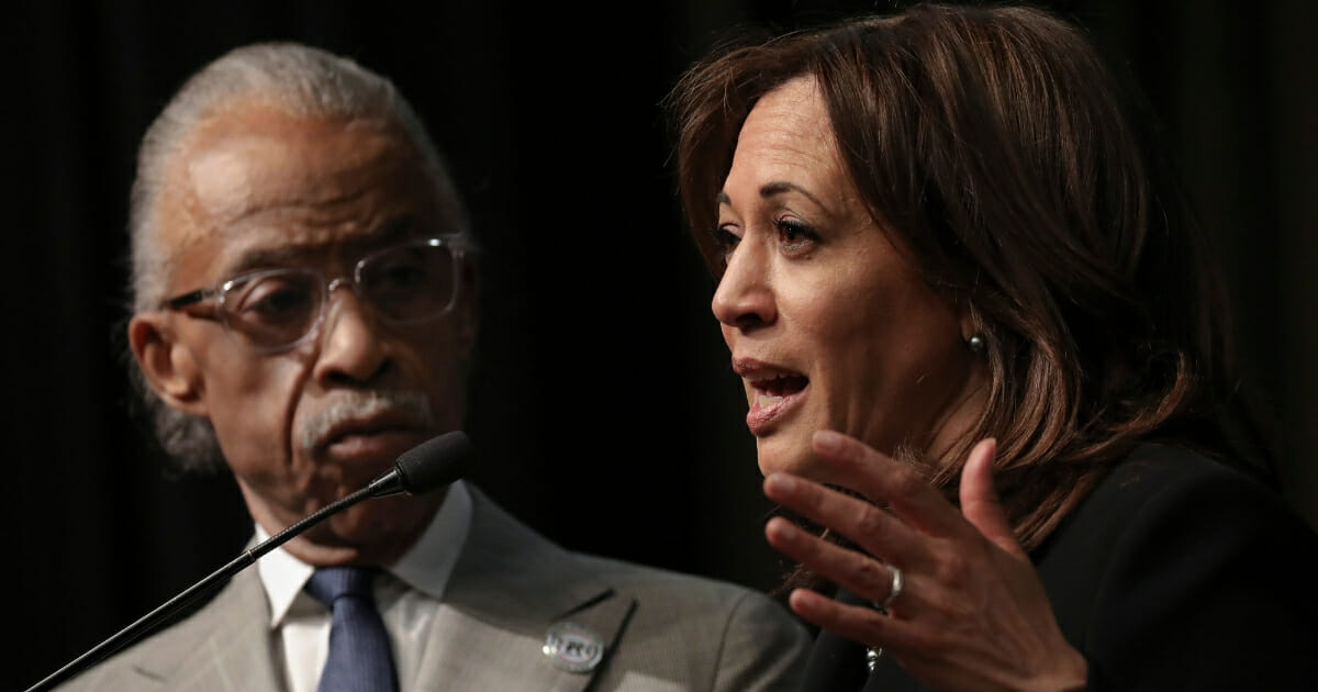 Rev. Al Sharpton looks on as Democratic presidential candidate U.S. Sen. Kamala Harris (D-CA) speaks at the National Action Network's annual convention.