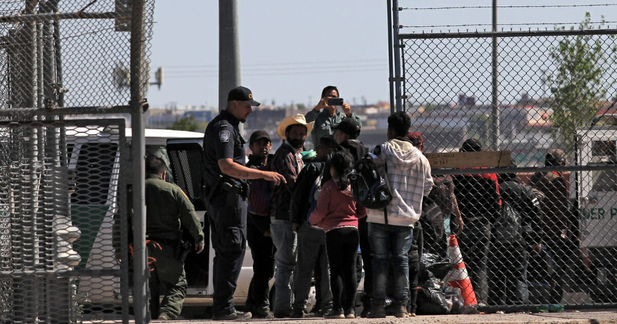 Central American migrants surrender to United States Border Patrol officers after crossing to El Paso, Texas.