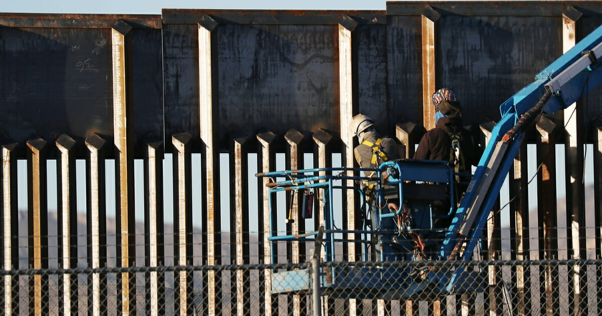 People work on the U.S./ Mexican border wall on February 12, 2019 in El Paso, Texas.