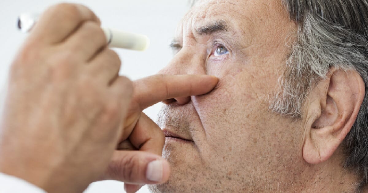 An opthallmologist examines a patient.