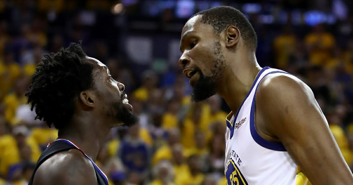 Kevin Durant of the Golden State Warriors has words with Patrick Beverley of the LA Clippers during Game One of the first round of the 2019 NBA Western Conference Playoffs at ORACLE Arena on April 13, 2019 in Oakland, California.