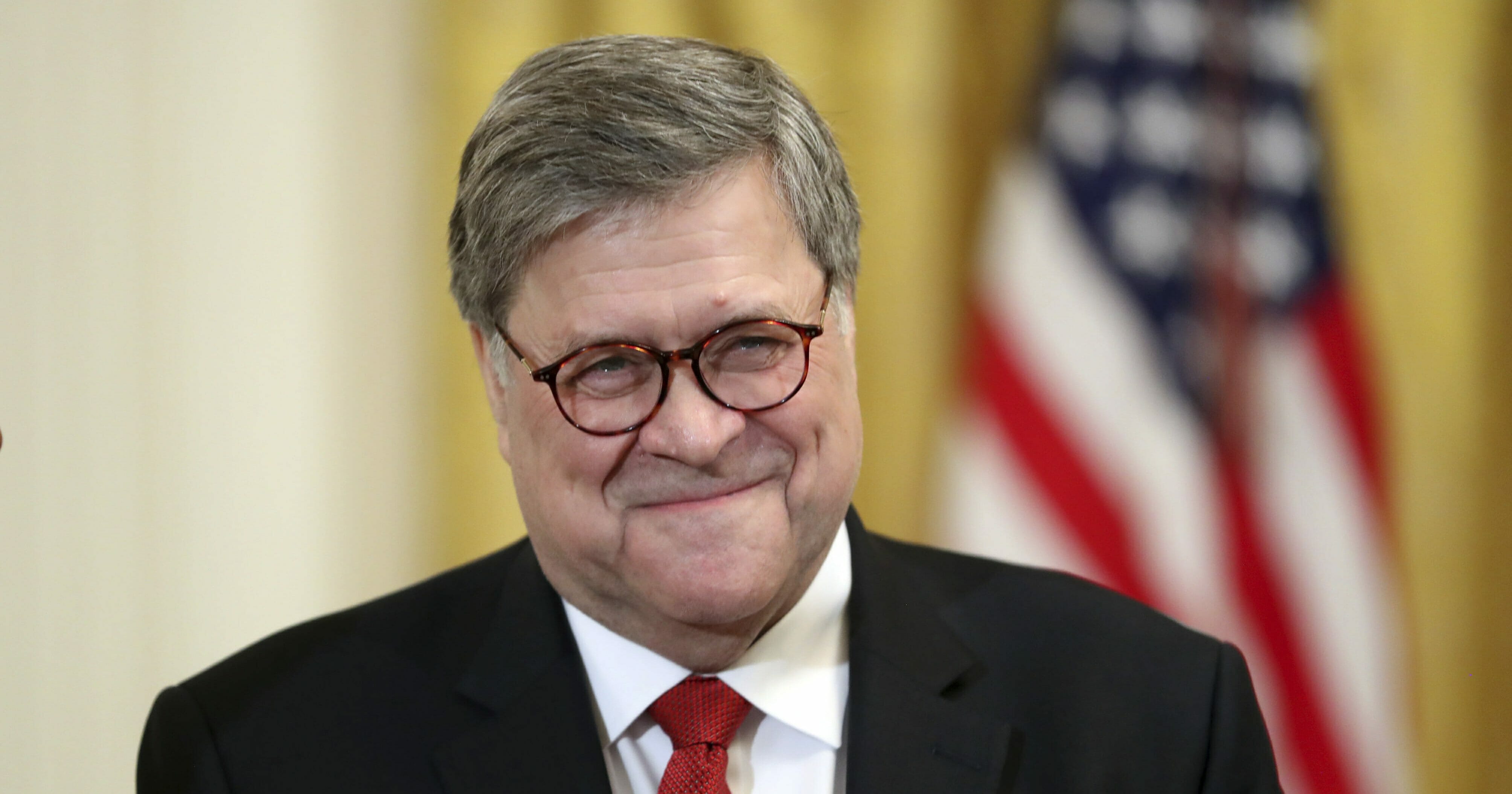 Attorney General William Barr smiles as he waits for President Donald Trump to speak at the 2019 Prison Reform Summit and First Step Act Celebration in the East Room of the White House in Washington, Monday, April 1, 2019.