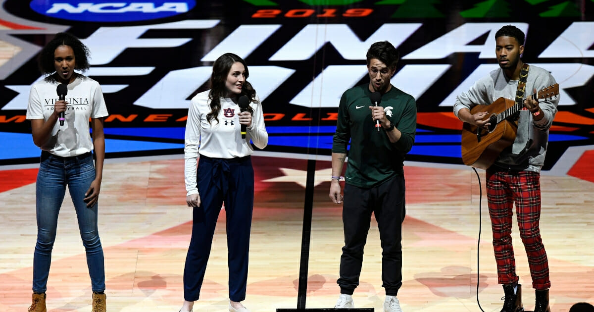 (L-R) Student athletes Milla Ciprian, Morgan Kull, Zach Kovan and Dorian Williams Jr. perform the national anthem prior to the 2019 NCAA Final Four semifinal between the Auburn Tigers and the Virginia Cavaliers at U.S. Bank Stadium on April 6, 2019 in Minneapolis.