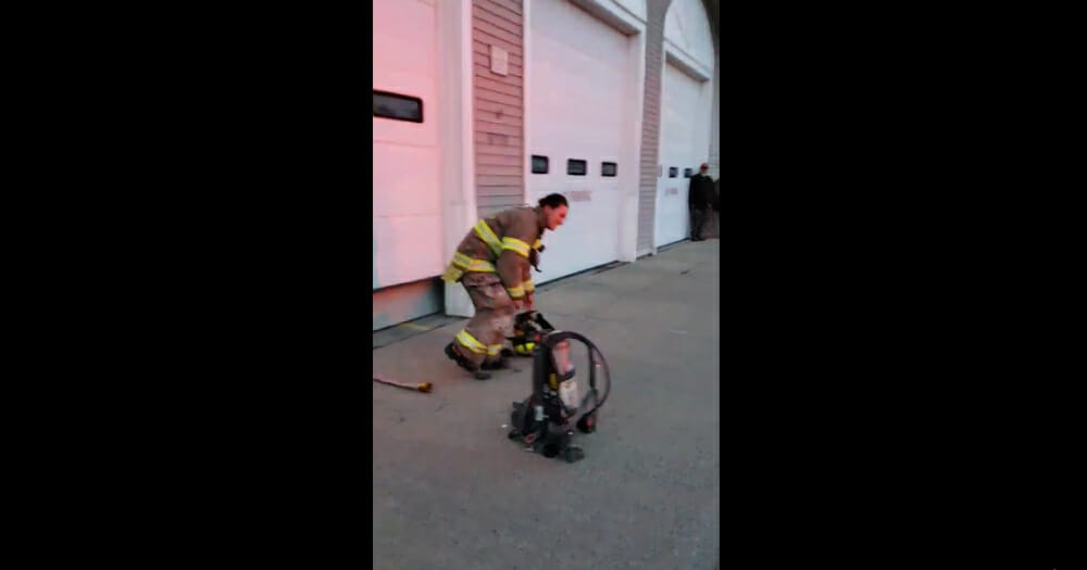Firefighter drops to her knee.