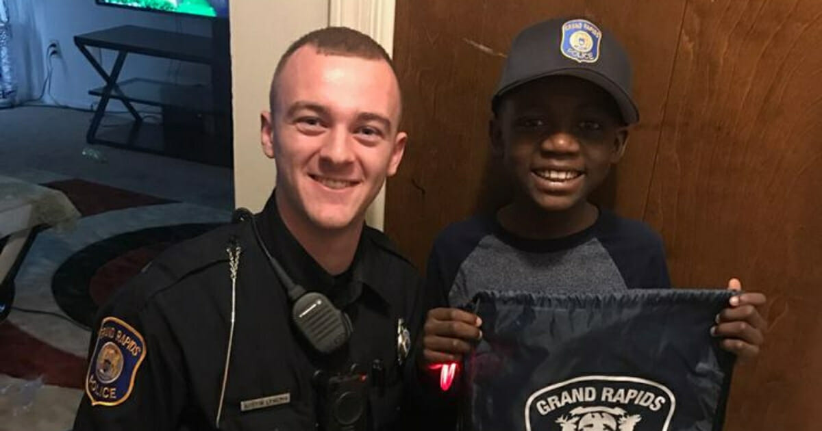 Police officer, left, and little boy, right.