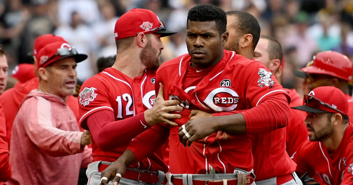 Yasiel Puig of the Cincinnati Reds is restrained after benches clear in the fourth inning during the game against the Pittsburgh Pirates at PNC Park on April 7, 2019 in Pittsburgh.