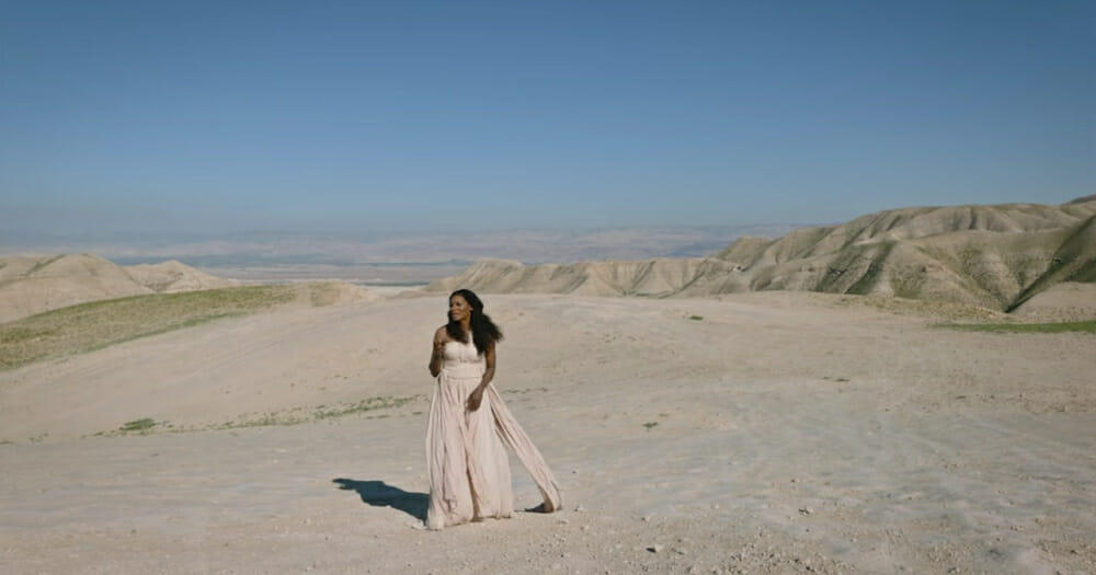 A woman standing in the desert.